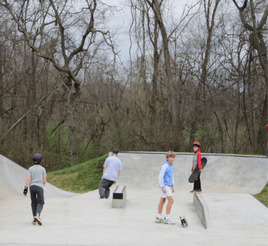 A group enjoys skating at the skate park